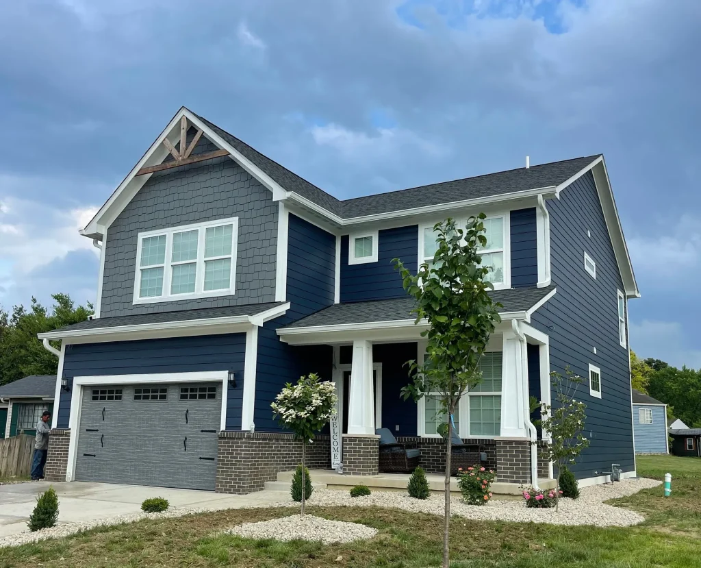 Modern blue house with new landscaping.